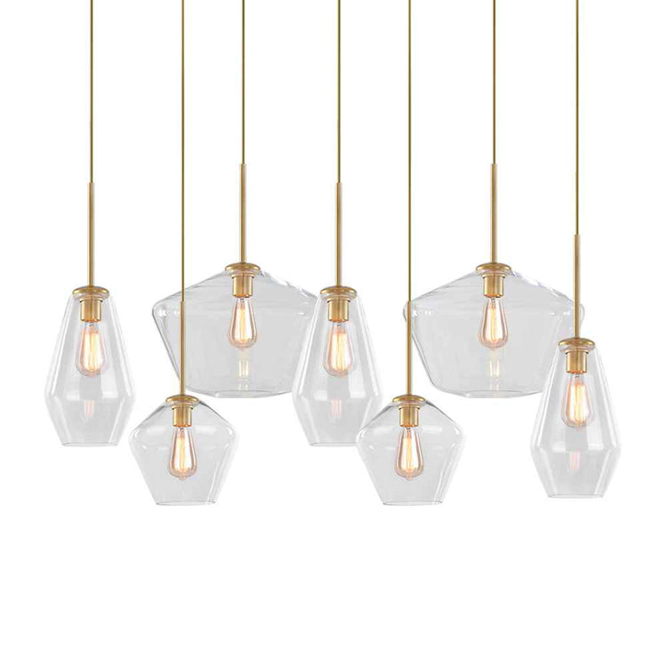 Groupe de 7 abat-jours en verre transparent géométrique avec ampoules à filament, armatures dorées.
