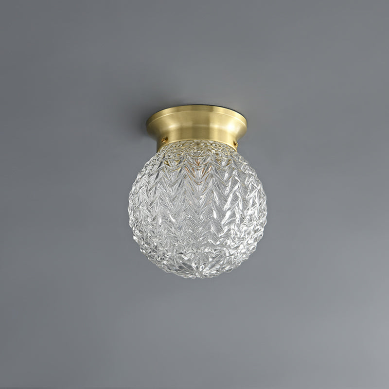 Plafonnier semi-encastré: globe en verre texturé argenté, monture en laiton.