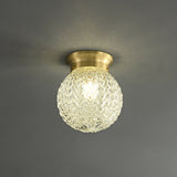 Plafonnier semi-encastré: globe en verre texturé doré, monture en laiton.