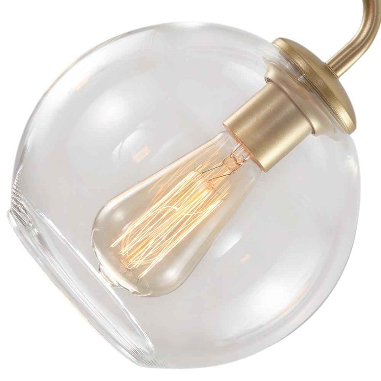 Verre soufflé rond avec ampoule à filaments dorés et monture laiton.