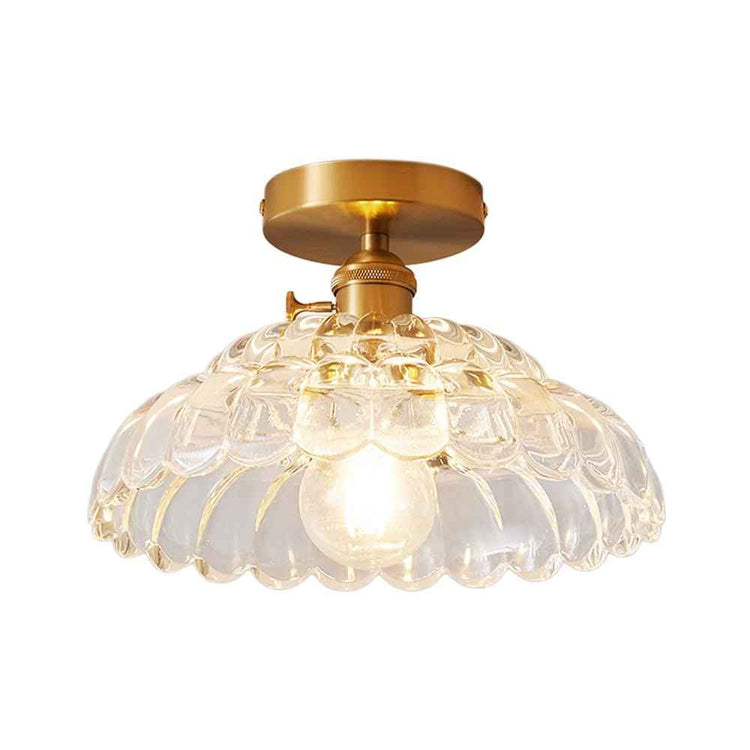 Plafonnier 1 lumière, dôme en verre transparent à bords ondulés, finition dorée.