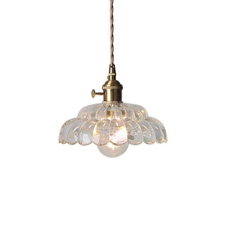 Suspension en verre transparent style lotus avec ampoule visible, monture laiton.