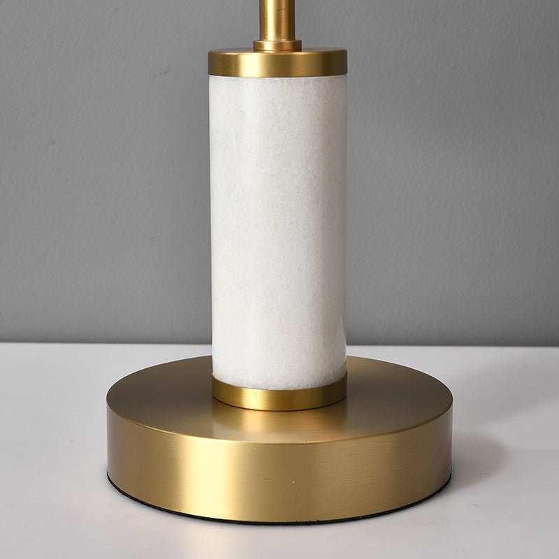 Base de lampe à poser : cylindre blanc en matériau texturé sur disque doré.