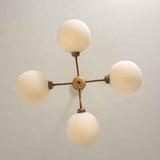 Lustre sputnik 4 lumières laiton, quatre abat-jours en verre opale sphériques