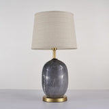 Lampe à poser avec abat-jour tissu beige et base céramique gris marbré, piètement laiton