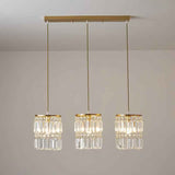 Suspension 3 lumières : trois abat-jour cylindriques en cristal, base et tiges dorées