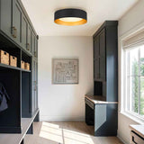 Plafonnier LED tambour noir, intérieur doré et verre laiteux diffus.