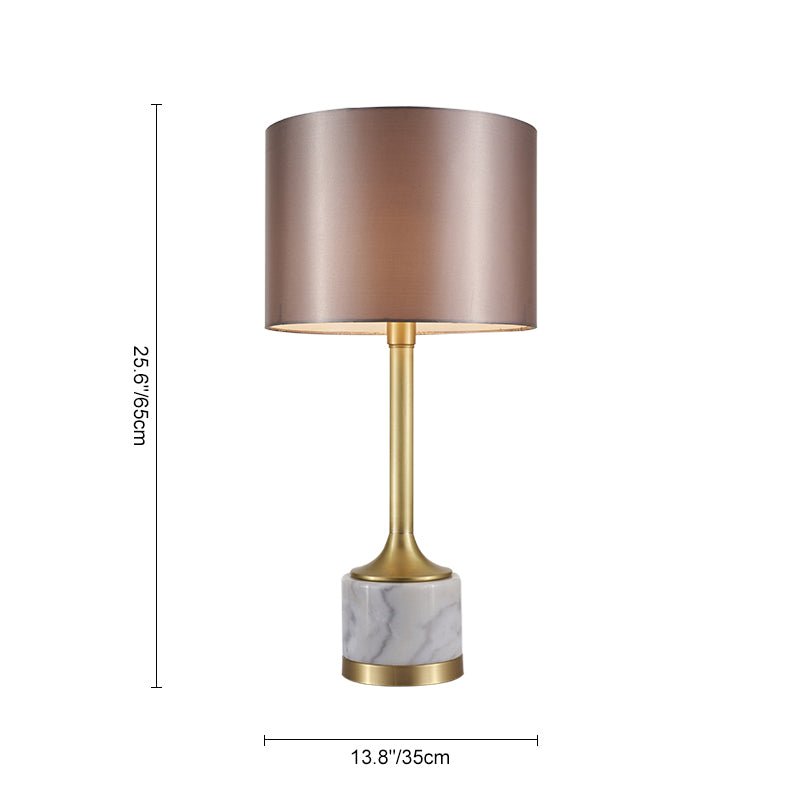 Lampe à poser : abat-jour en tissu cylindrique, base marbre claire et tige laiton.