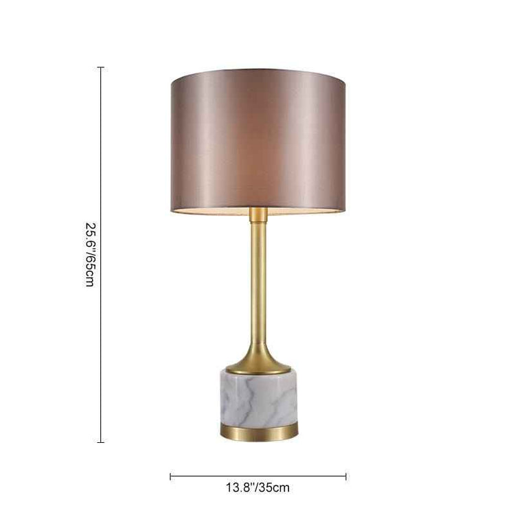Lampe à poser : abat-jour en tissu cylindrique, base marbre claire et tige laiton.