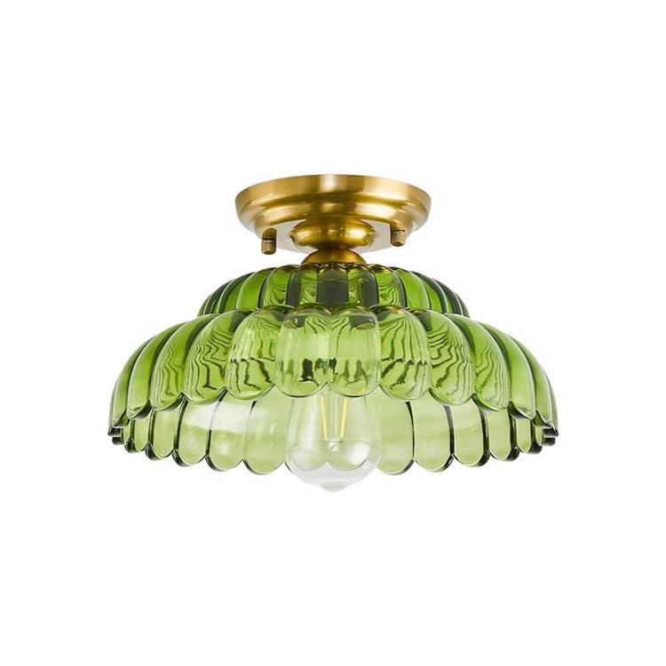 Plafonnier dôme en verre vert, forme bombée nervurée et base dorée.